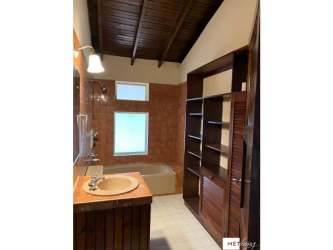 Bathroom with wood ceiling bathtub built-in shelves in country estate Cerro Azul