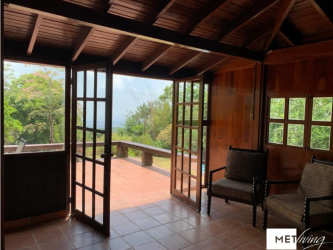 Living dining with wooden beams french doors opening to outdoor patio garden Cerro Azul