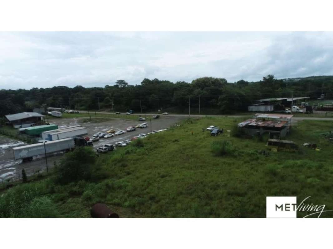 Aerial of commercial-industrial vacant land with parking, trucks, open terrain Chepo Panama