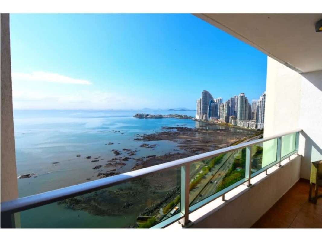 Modern balcony with glass railing offering ocean and city skyline views at PH Terrawind, Panama