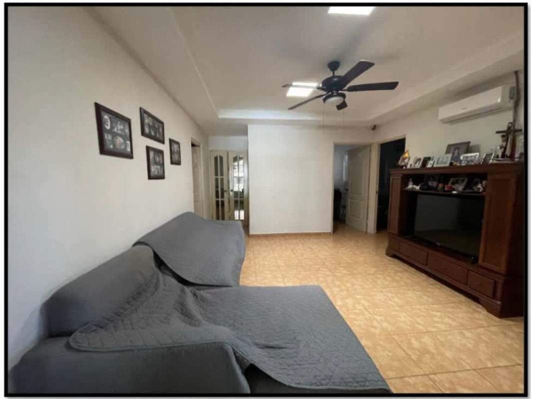 Living room with air conditioning, ceiling fan, and wall art in Villa Zaita Panama