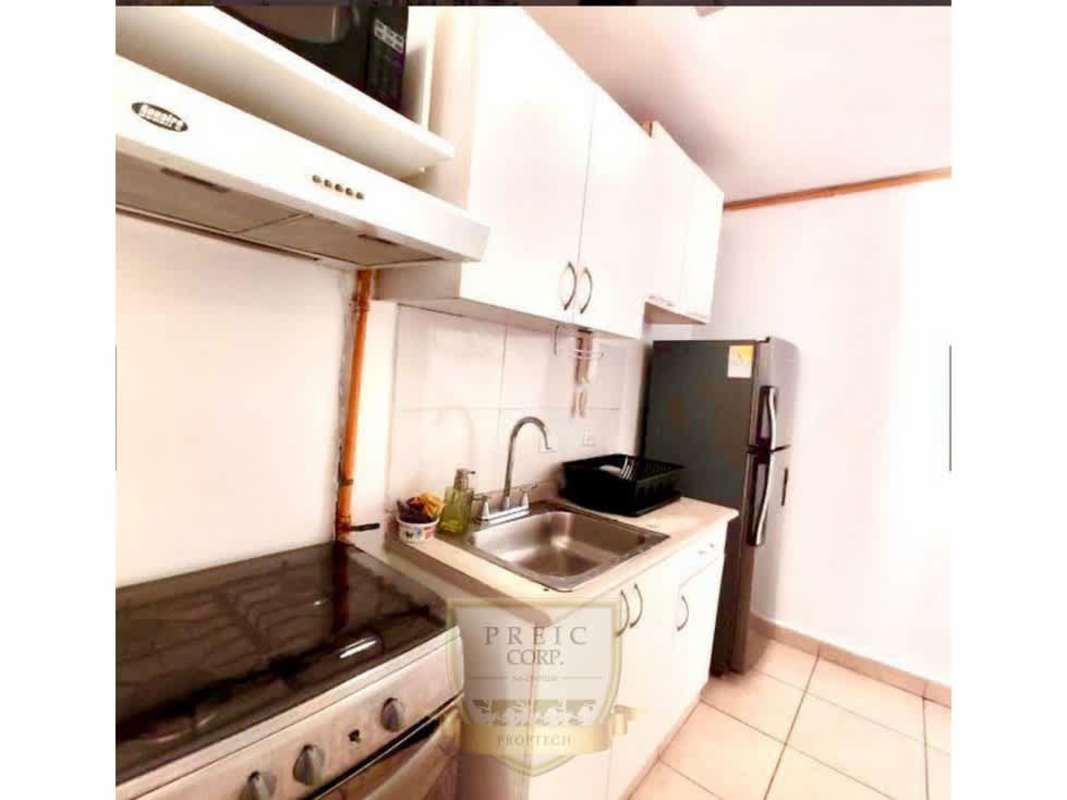 Compact kitchen with appliances in furnished apartment PH Brisas de España Carrasquilla Panama