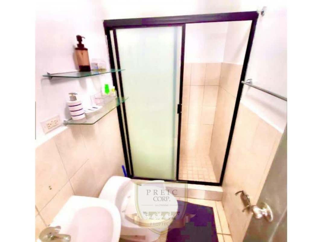 Rooftop swimming pool with lounge chairs and skyline view in PH Brisas de España Panama City