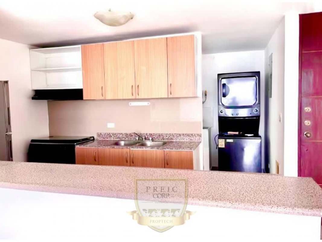 Modern compact kitchen with granite counter and laundry space in Central Park Towers Pueblo Nuevo Panama City