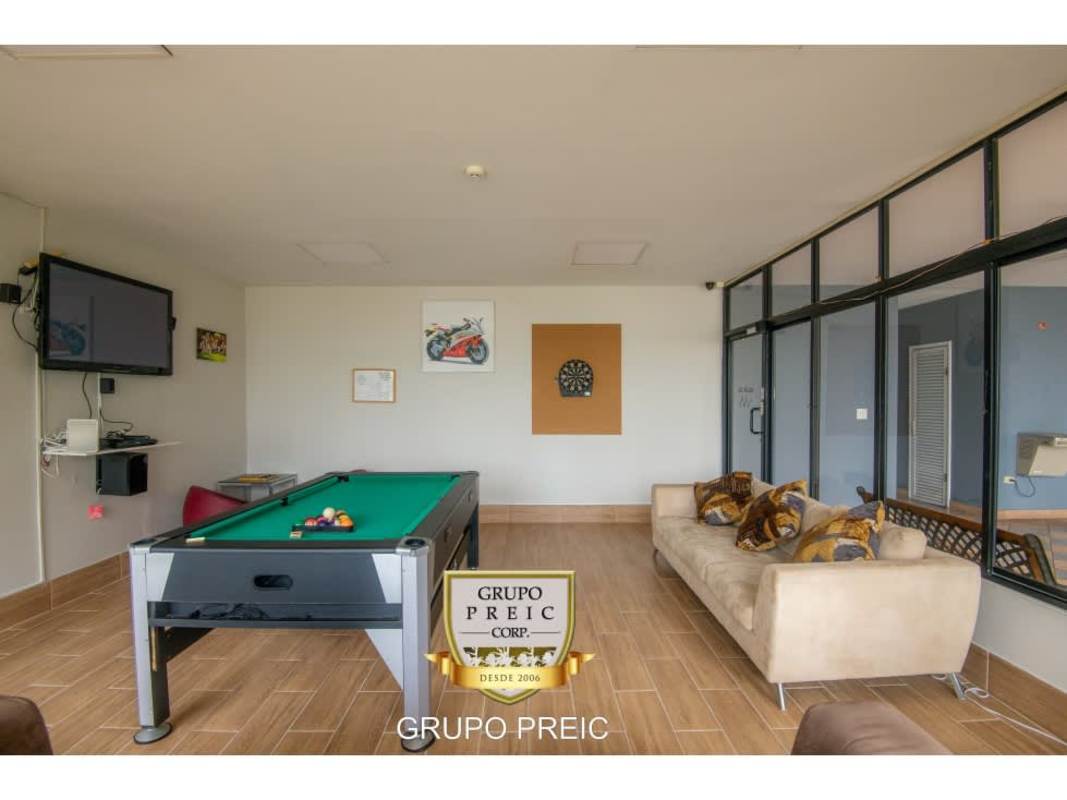 Spacious closed kitchen with island and appliances in penthouse PH Plaza Real