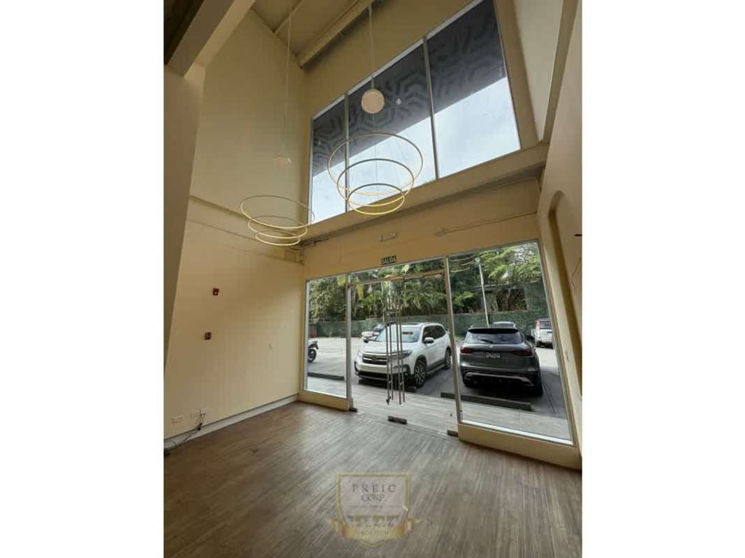 Commercial space with double-height glass doors and pendant lights Plaza San Francisco Panama for rent
