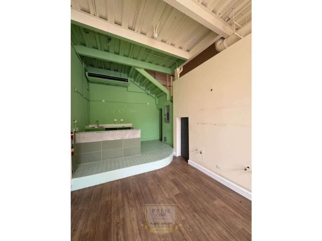 Long retail unit interior with arched niches and exposed beams Plaza San Francisco Panama