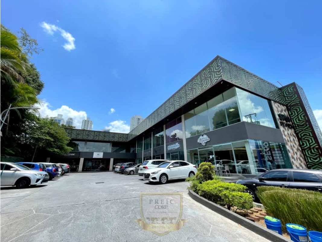 Contemporary commercial plaza with large glass windows and parking lot in San Francisco Panama