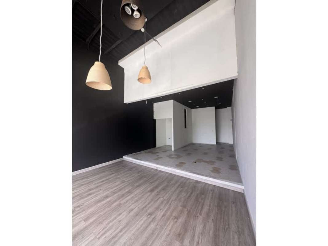 Empty commercial interior with elevated platform and high ceilings in Panama City