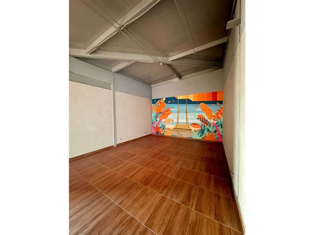 Spacious industrial style space with wood tiles, mural wall and ceiling beams at San Francisco Plaza Panama