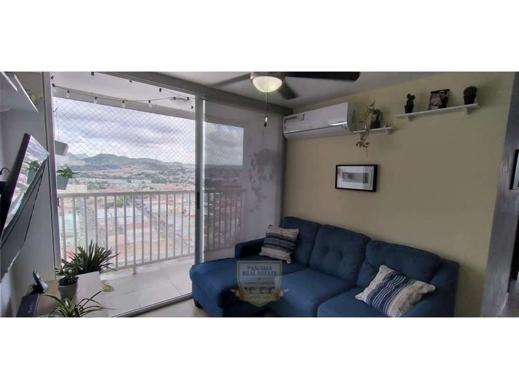 Living and dining area with balcony, ceiling fan, and city skyline view in PH Alegría Panama City