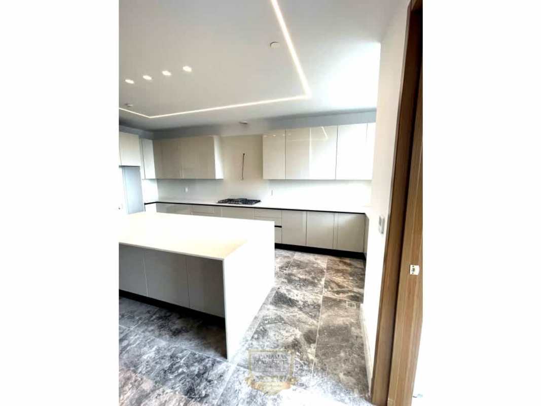 Minimalist kitchen island design with marble flooring at PH The Reserve Santa María