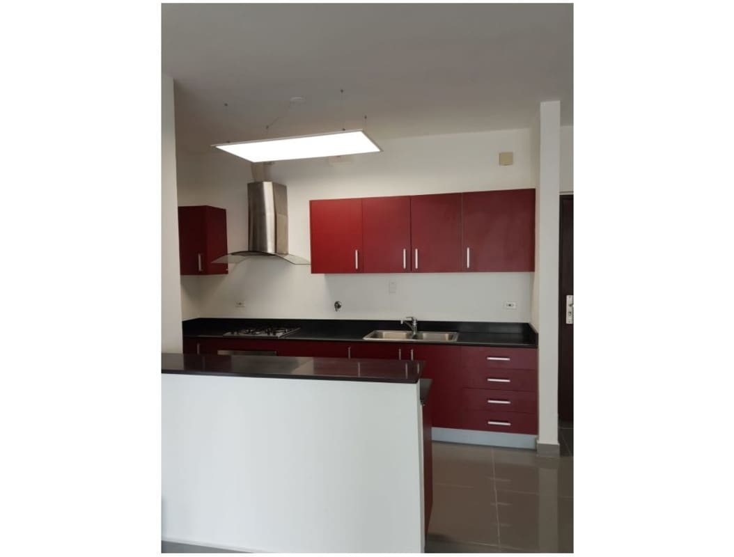 Contemporary kitchen with red cabinetry, granite countertop, built-in appliances PH Quartier 74 Panama