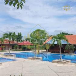 Townhomes with red tiled roofs and patios surrounded by gardens in PH Las Palmas Panama