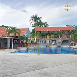 Large swimming pool with tropical landscaping in PH Las Palmas Río Hato Panama