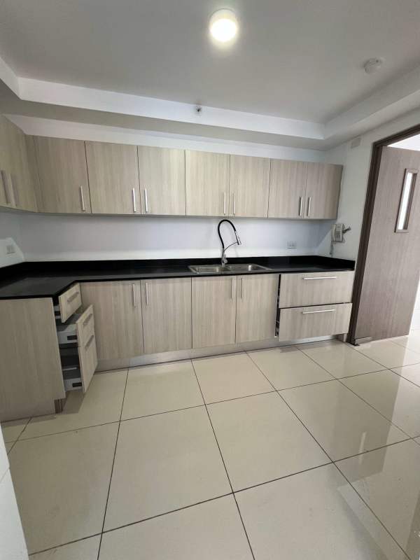 Covered balcony with glass railing offering Panama skyline and mountain views