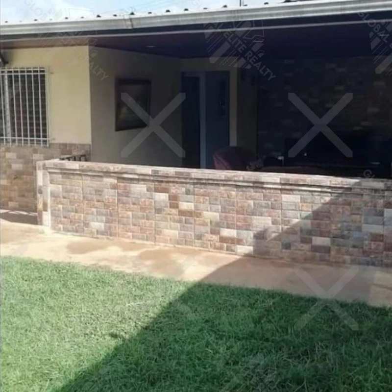 Back patio with roof, garden view and tiled floor in Praderas San Antonio Panama