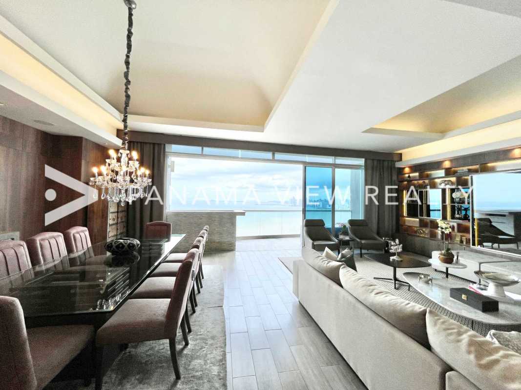 Open concept luxury living room with floor-to-ceiling windows, ocean view, marble floors in PH The Pearl Costa del Este Panama
