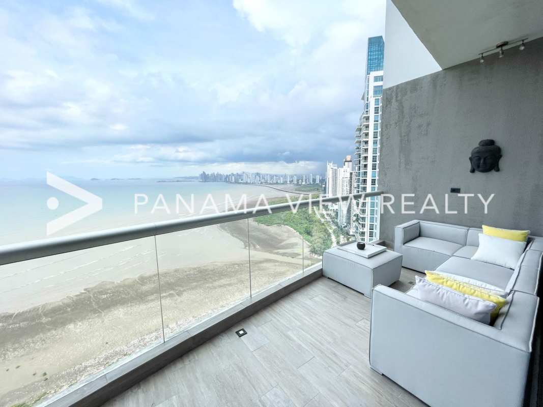 Luxury living room with ocean view floor-to-ceiling windows in PH Pearl penthouse Costa del Este Panama