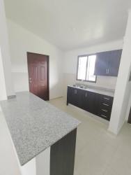 Bright bedroom with white ceramic tile and window in new house Cerro Silvestre Panama