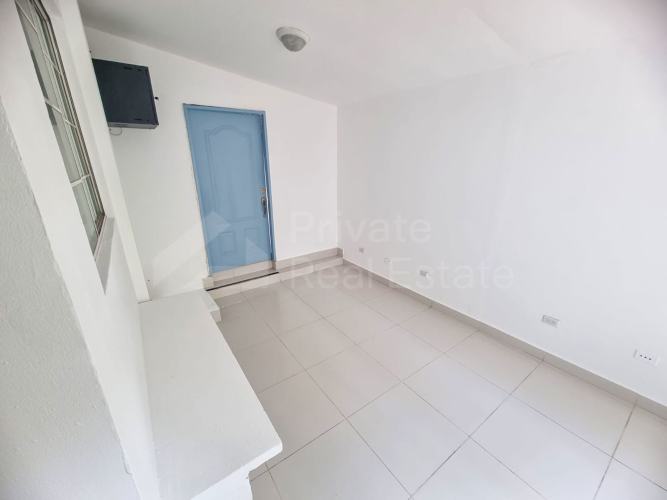 Kitchen with blue cabinets granite tops and large windows PH Obarrio Residences Panama