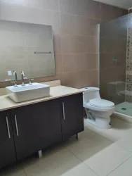Bathroom with glass shower and modern vanity in Panama Pacifico apartment