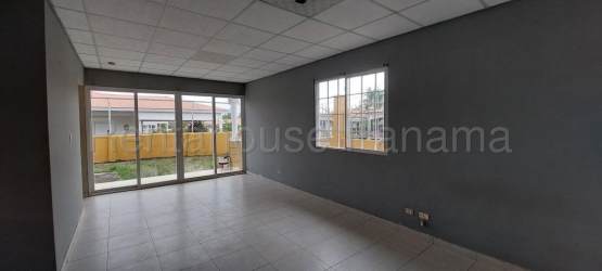 Modern kitchen with wood cabinets, granite countertops, large windows in La Chorrera Panama