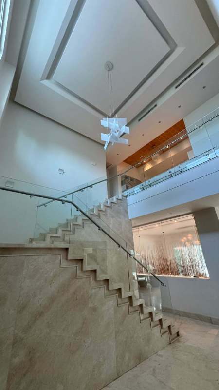 Marble floating staircase glass railing chandelier foyer Toscana Costa del Este