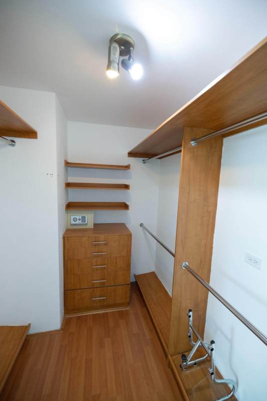 Modern walk-in closet with shelving drawers in PH Loft 41 loft apartment Punta Pacifica Panama