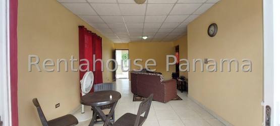 Kitchen with white cabinets tile floor bright window in La Chorrera house Panama