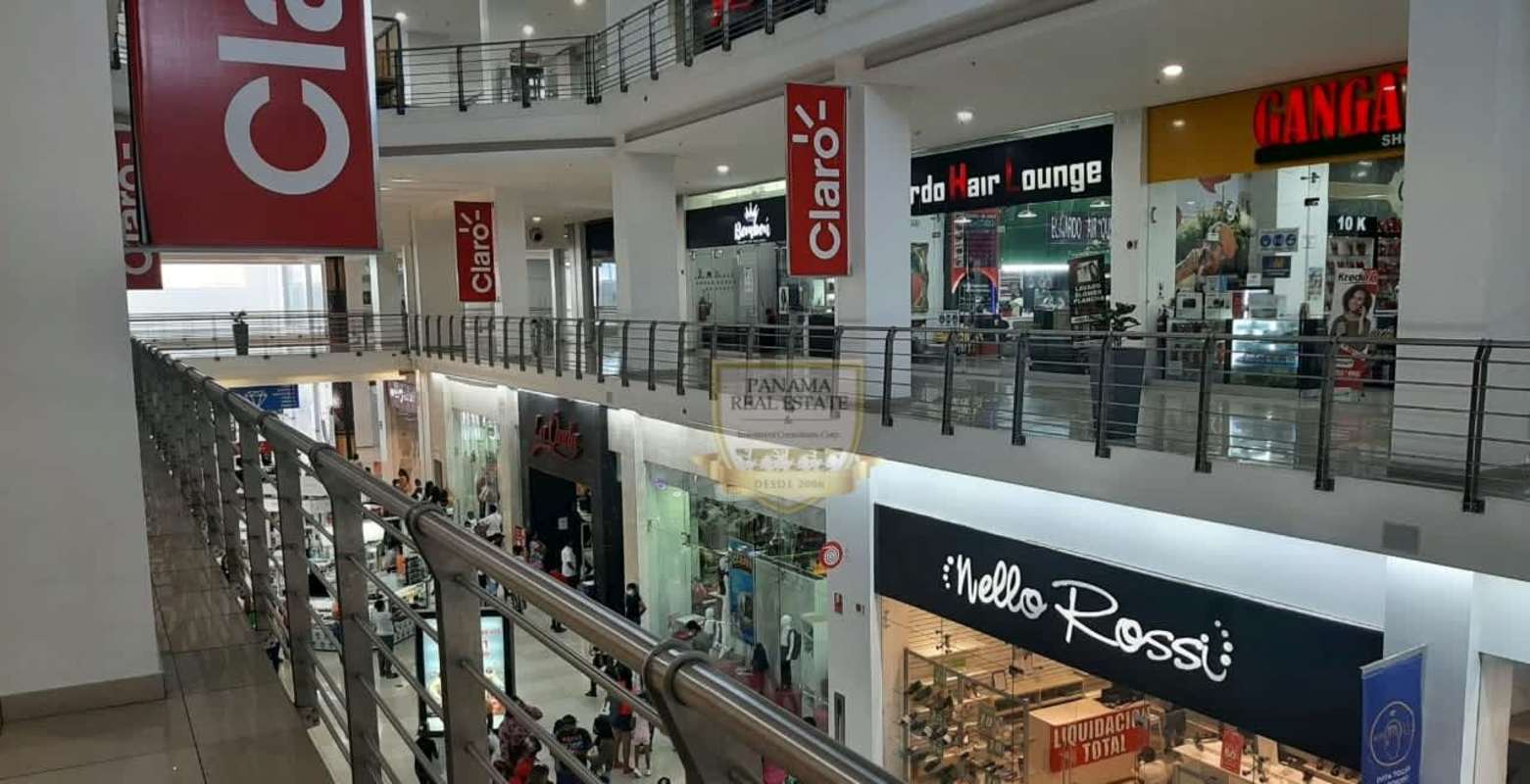 Multi-level mall corridor at Los Andes Mall with escalators and retail stores