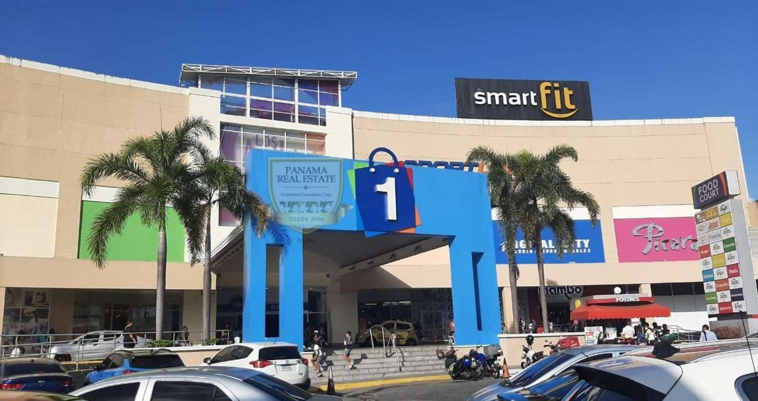 Modern colorful exterior entrance of Los Andes Mall Panama City with palm trees and parking lot