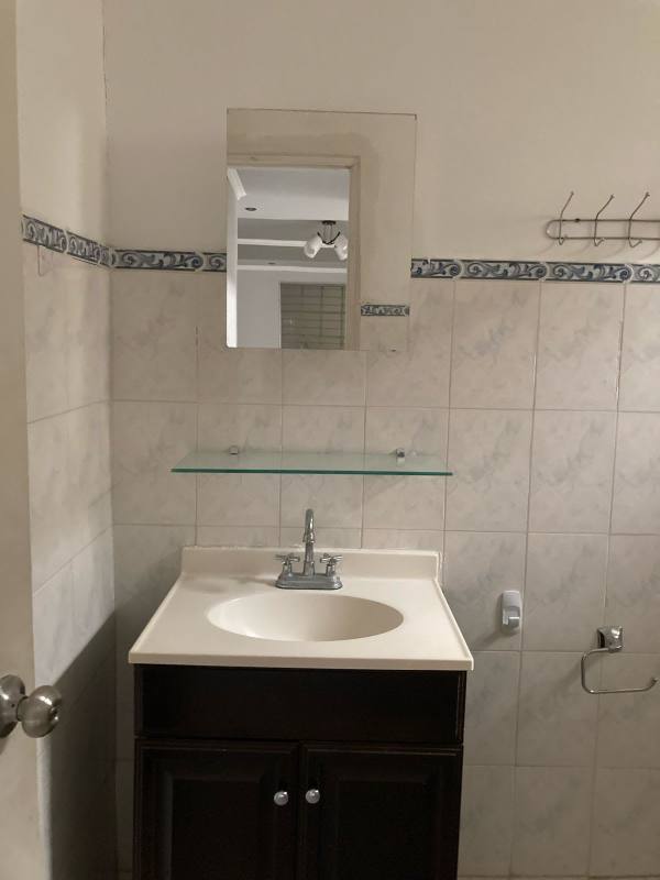 Spacious living room with tiled floor and ceiling fan in Villa Lucre house