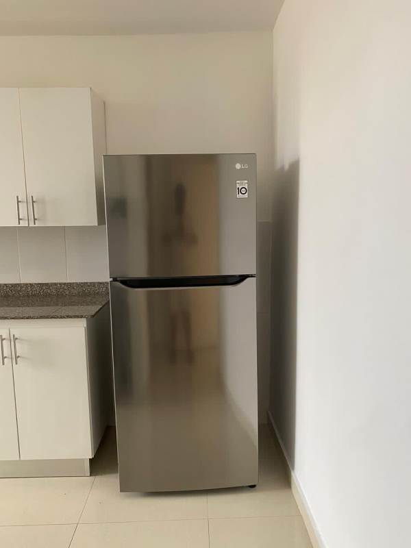 White cabinetry granite countertop kitchen with stainless steel appliances Villa de las Fuentes apartment Panama