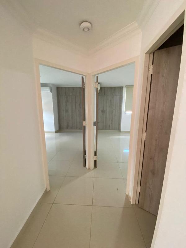 Bright hallway with tile flooring leading to bedrooms showing closets in El Dorado Panama apartment