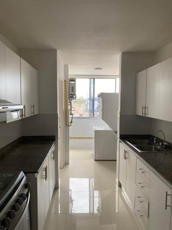 Laundry kitchen area with appliances and window Villa de las Fuentes Panama apartment