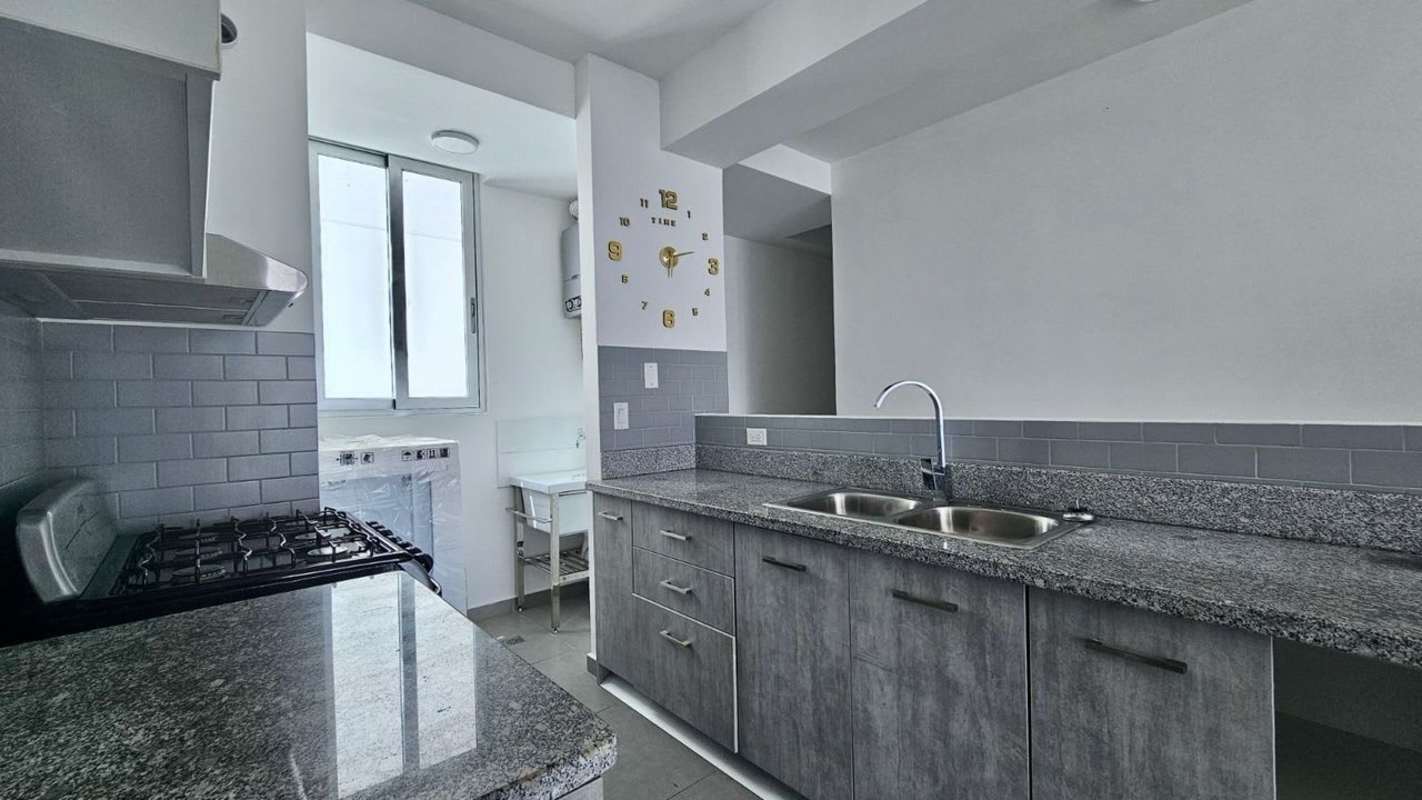 White kitchen with granite counters and stainless steel sink in PH La Cresta Panama