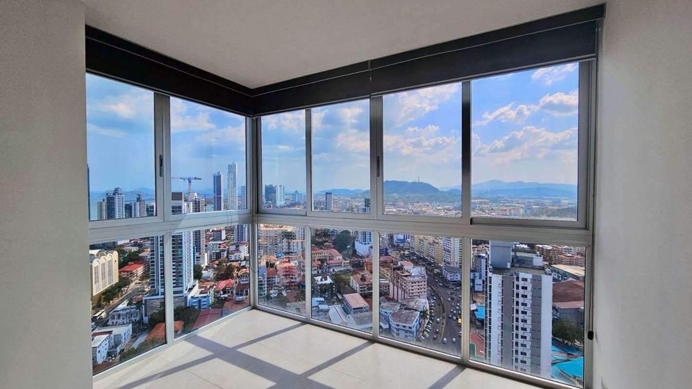 Interior corner space large glass windows overlooking Panama City skyline PH La Cresta