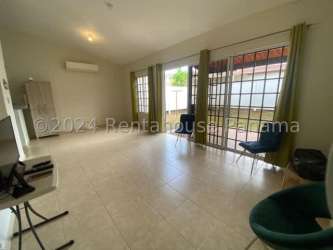 Swimming pool with lounge chairs umbrellas fenced recreation Los Pinos Arboledas La Chorrera Panama