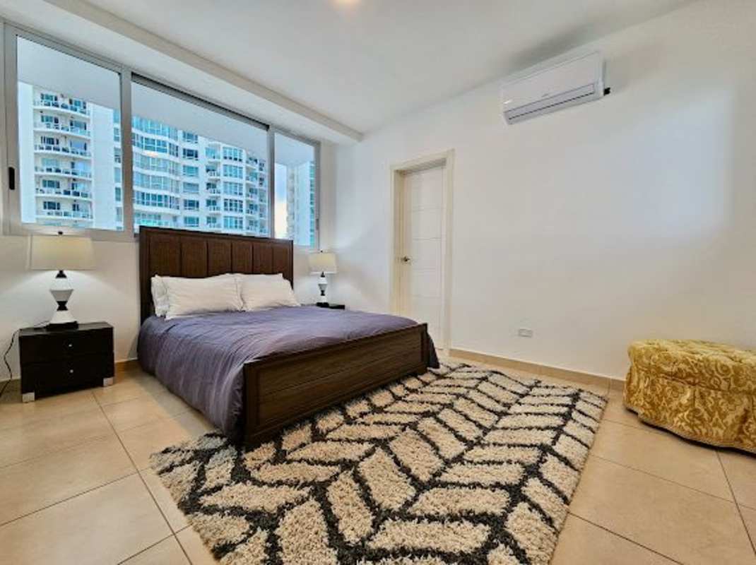 Bedroom featuring large window with ocean and skyline views, modern furniture PH Pacific Point Panama