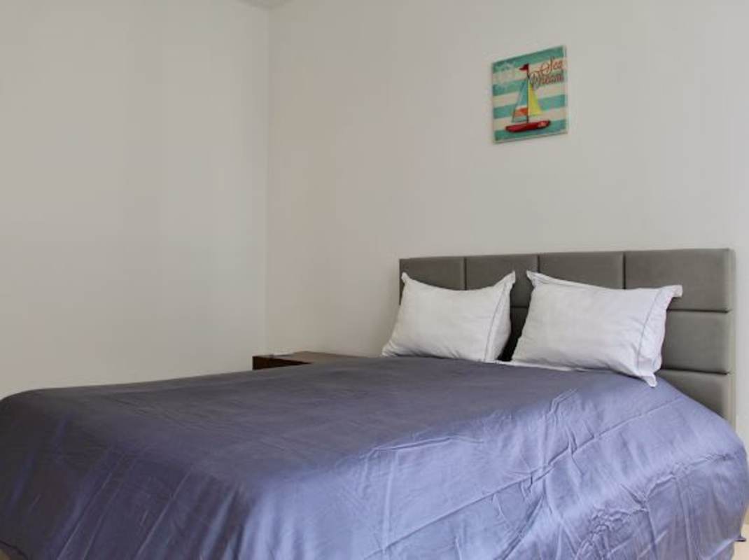 Covered balcony with glass railing overlooking high-rise towers and ocean in Punta Pacifica Panama