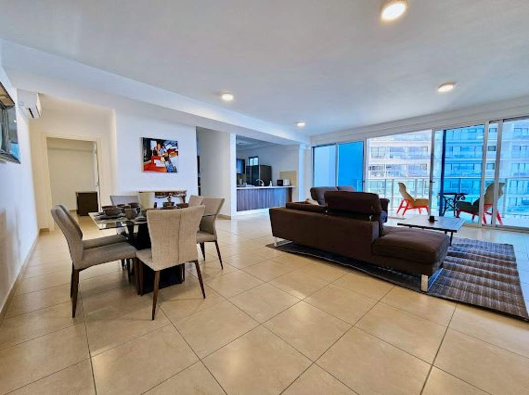 Spacious living dining room with panoramic windows, balcony access at PH Pacific Point Panama City