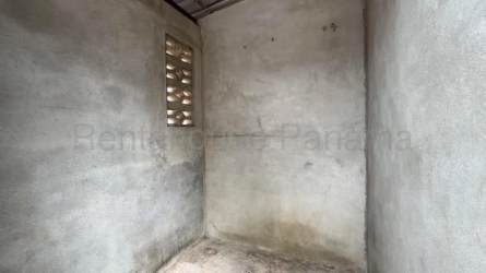 Laundry utility area with concrete sink, metal roof cover, louvered windows and rear door in La Chorrera