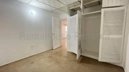 Bedroom with security bars on windows, beige ceramic floor and white walls in Panama