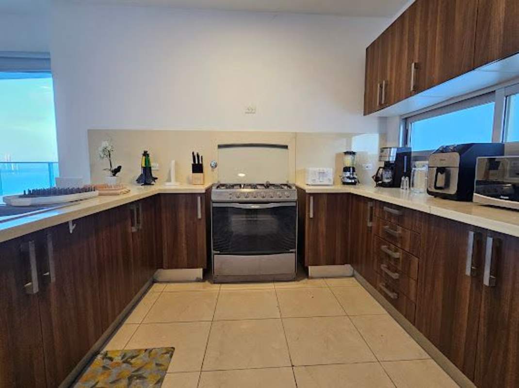 Living and dining area in luxury condo with balcony access and Pacific Ocean views in PH Ocean Club Panama