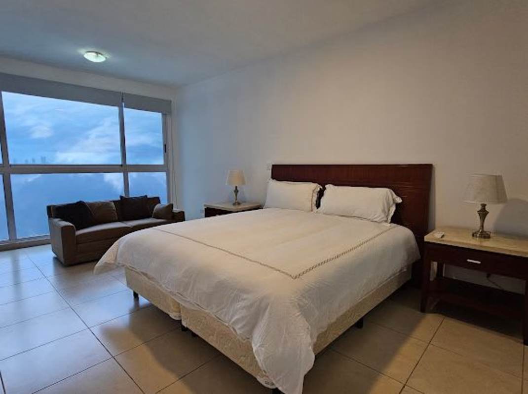 Bedroom with large window, king bed, city & ocean views in PH Ocean Club