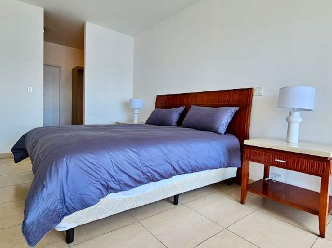 Bedroom with neutral colors, wood furnishings, minimalist style in PH Ocean Club