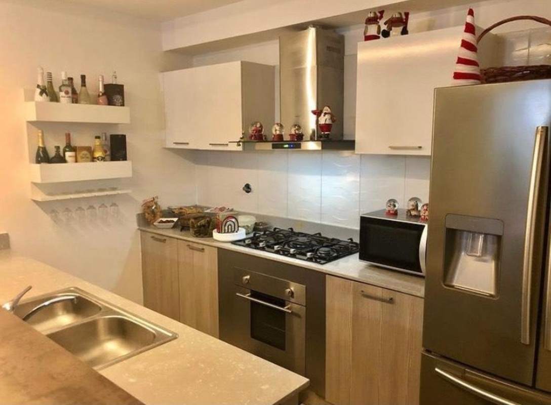 Apartment kitchen area with breakfast bar, open shelving, appliances at PH Metropolitan Park Panama City