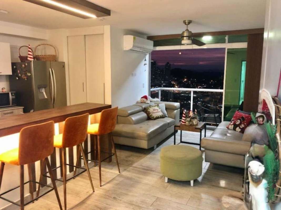 Living area connected to balcony with city view, open kitchen apartment PH Metropolitan Park Panama