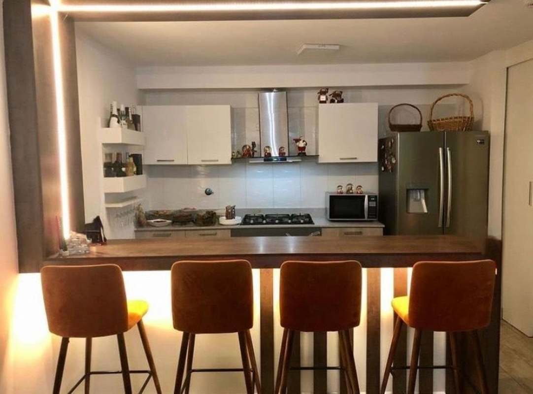 Modern kitchen with granite counter breakfast bar, appliances and open shelving apartment PH Metropolitan Park Panama City